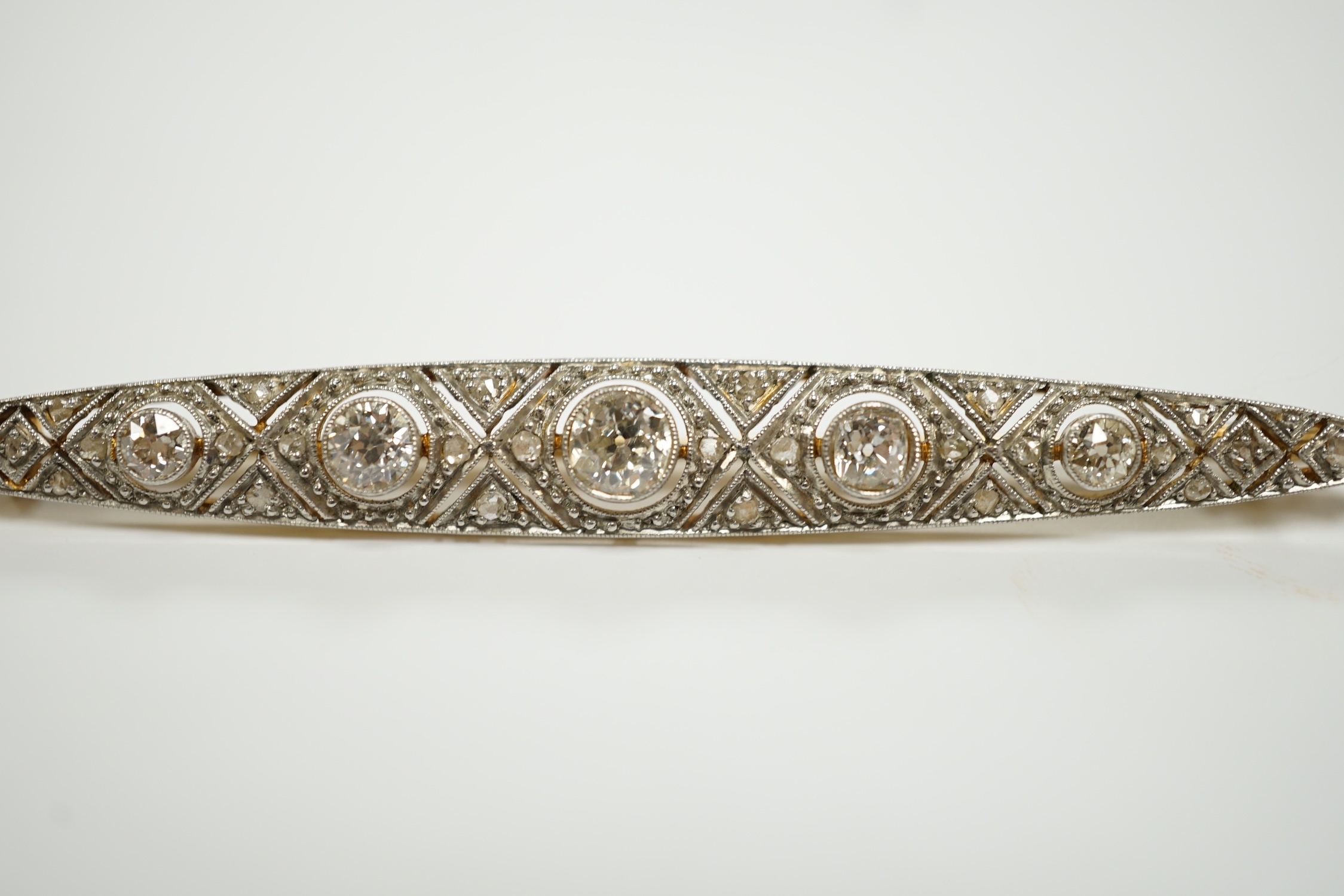 A Belle Epoque yellow and white metal mounted diamond cluster set navette shaped bar brooch, 69mm, gross weight 6.5 grams.